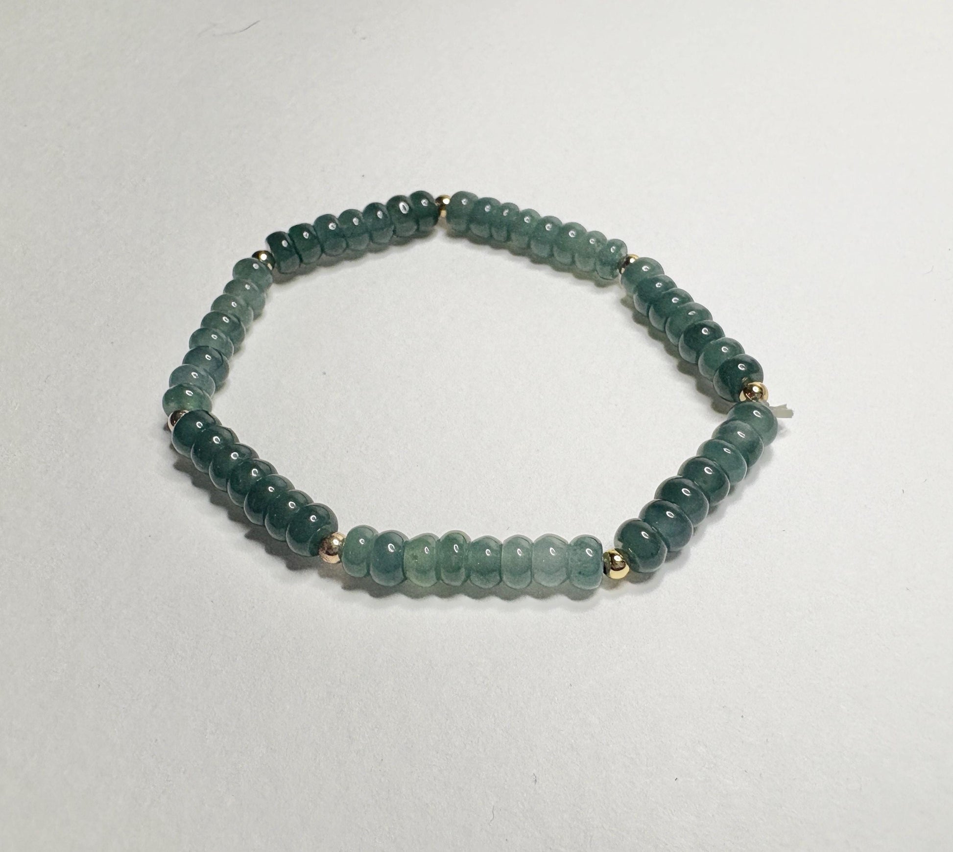 Guatemalan Type A jadeite jade stretch bracelet with gold beads.