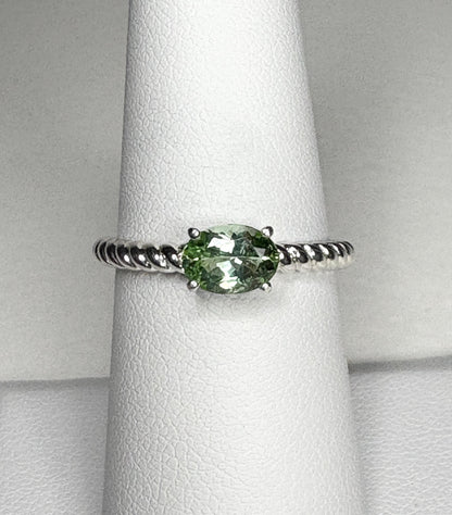 Sterling silver ring with an oval green tourmaline gemstone set east-west on a rope band.