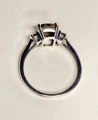A 10k white gold ring with a cushion-cut gold in quartz center stone and small diamonds.