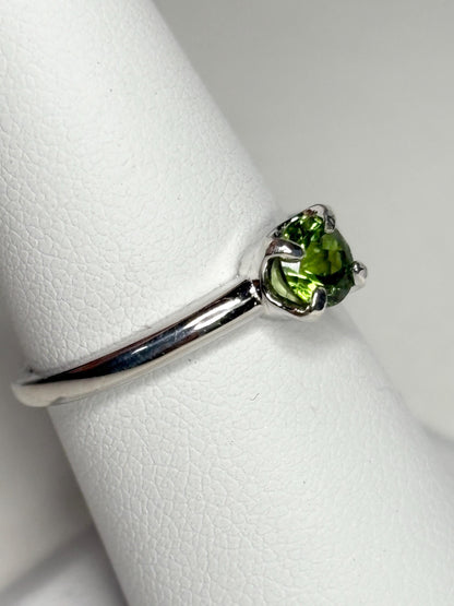 Sterling silver ring with a round, green tourmaline gemstone.