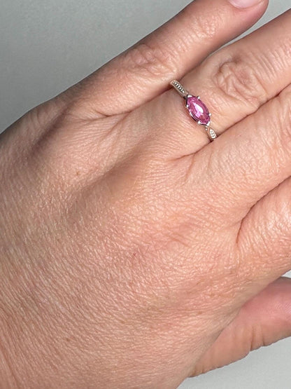 Sterling silver ring with a marquise-cut pink sapphire set east-west.