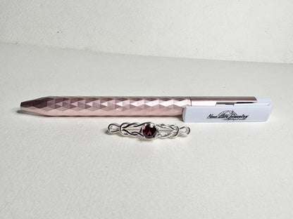 Rhodolite garnet Celtic knot style bar brooch in solid sterling silver.