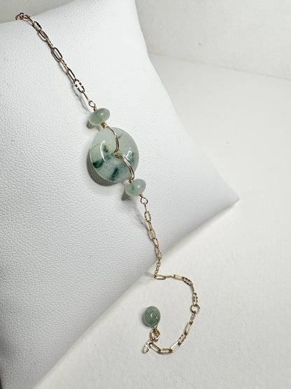 14k gold bracelet with a Type A Burmese jadeite Pi donut and moss in snow inclusions.
