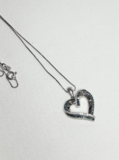 Sterling silver necklace with a heart pendant featuring blue and white diamonds.