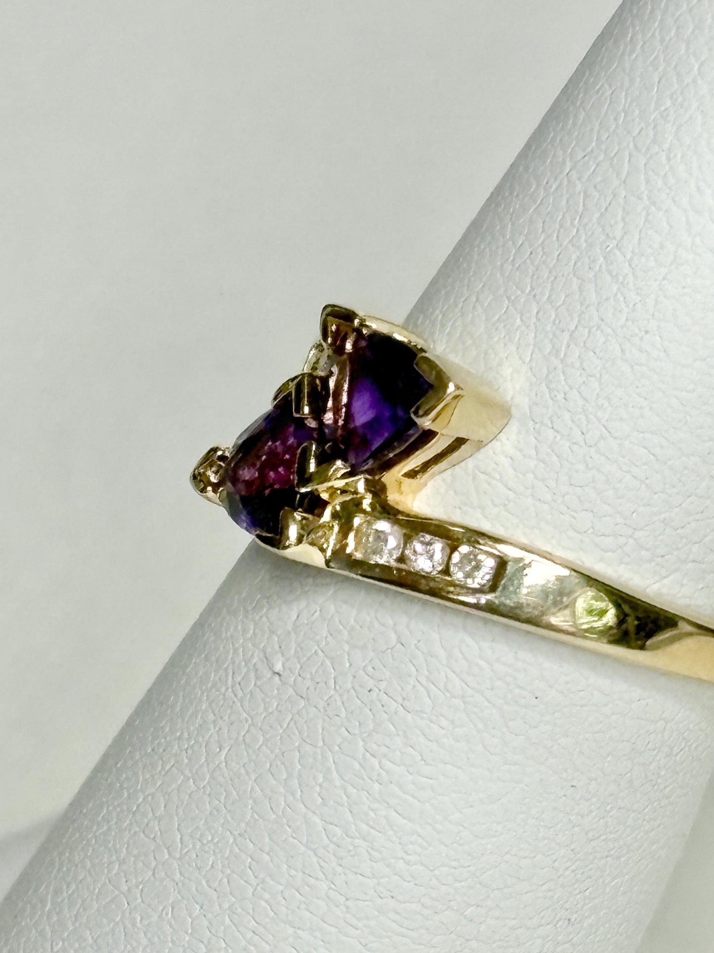 Amethyst trillion bypass ring with diamonds in solid 10k gold.