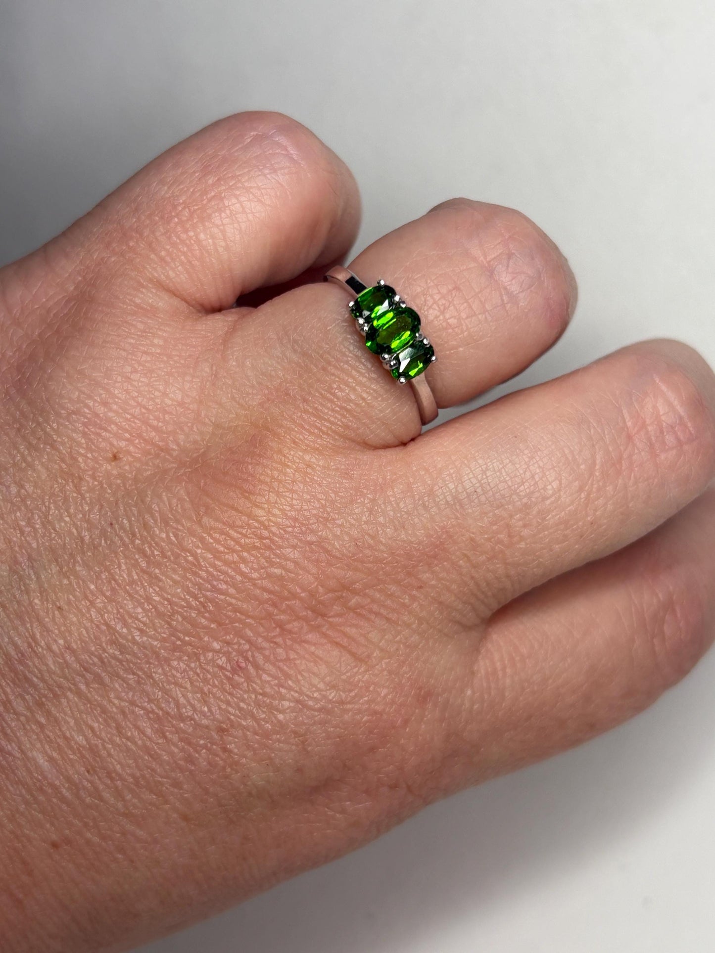 Sterling silver ring with three oval chrome diopside stones.