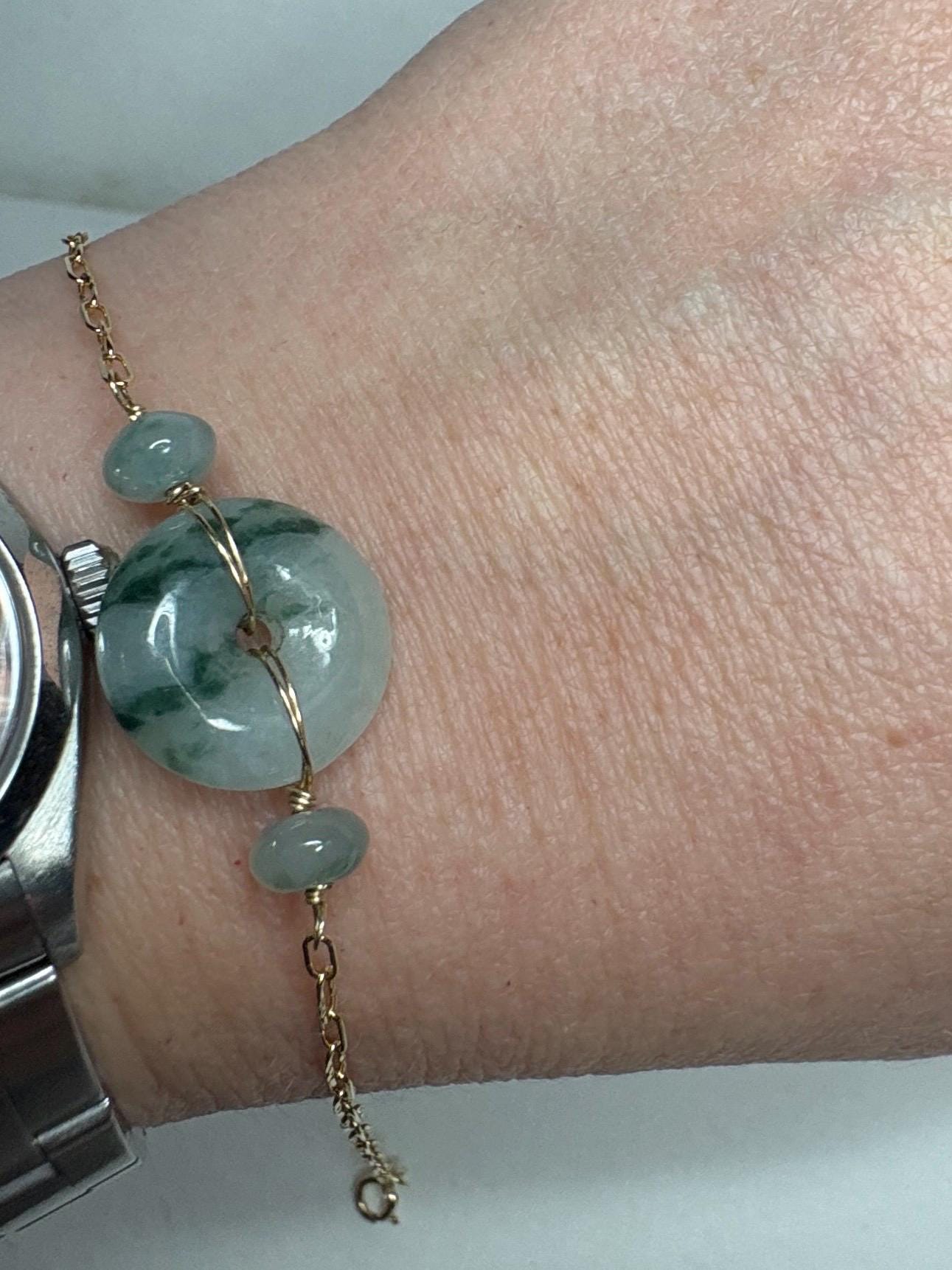 Burmese jadeite Pi donut bracelet with moss in snow pattern on 14k gold chain.