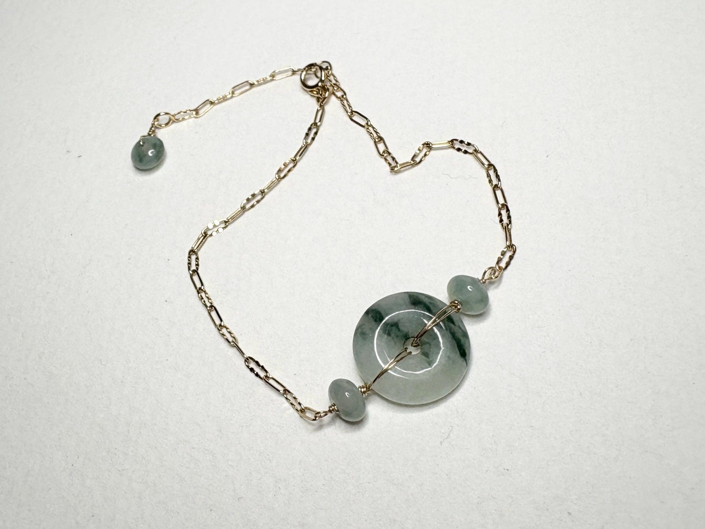 14k gold bracelet with a Type A Burmese jadeite Pi donut and moss in snow appearance.