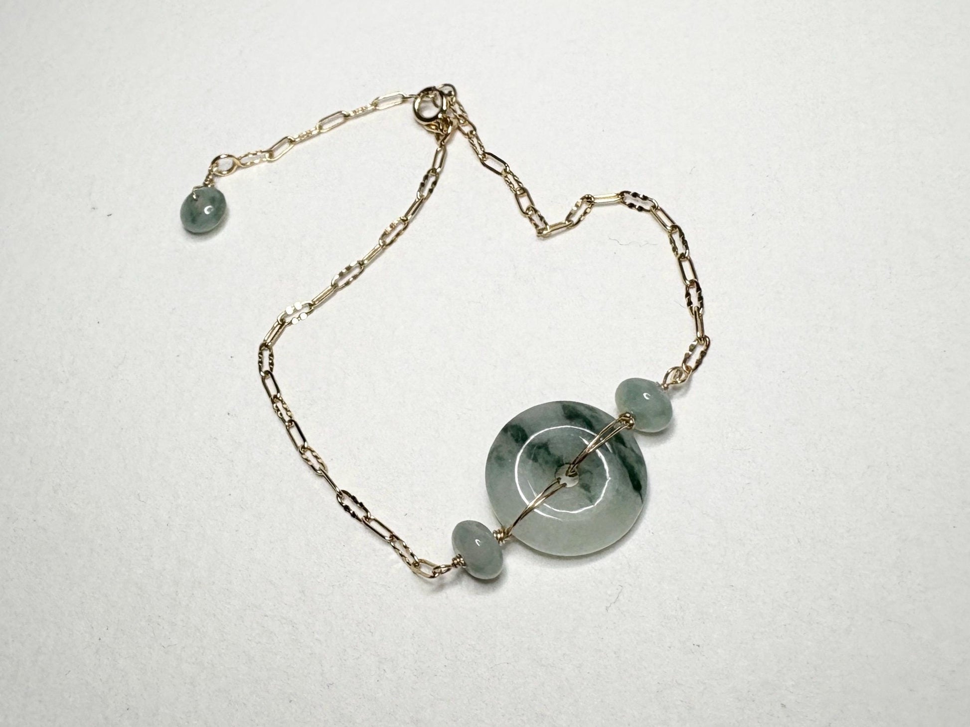 14k gold bracelet with a Type A Burmese jadeite Pi donut and moss in snow appearance.