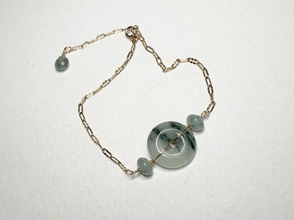14k gold bracelet with a Type A Burmese jadeite Pi donut and moss in snow appearance.