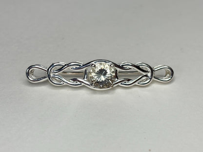 Sterling silver brooch with a yellow Oregon sunstone and Celtic knot design.