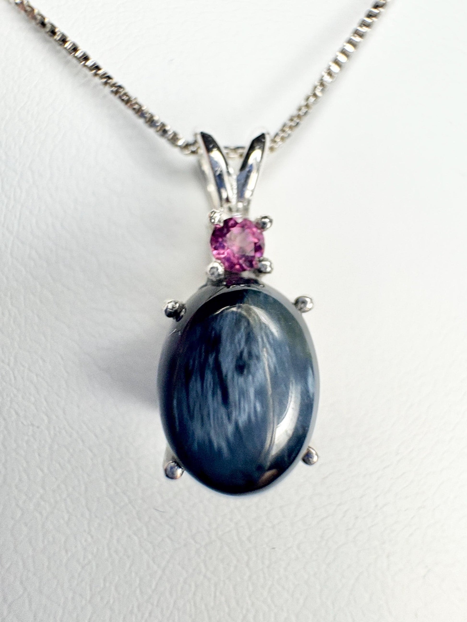 Sterling silver pendant necklace with oval blue pietersite and rhodolite garnet.
