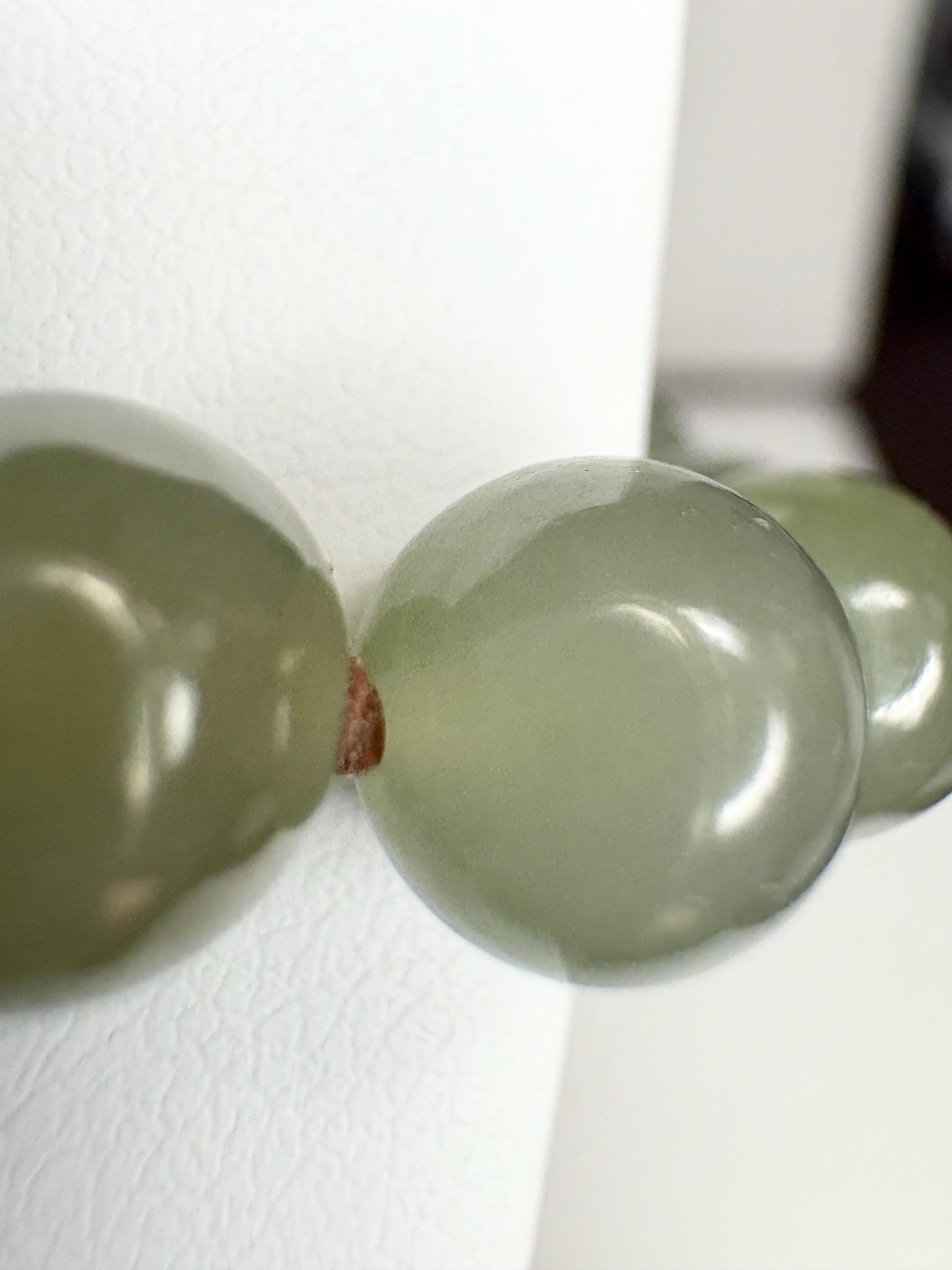 Nephrite Hetian jade knotted bead bracelet with sterling silver toggle.
