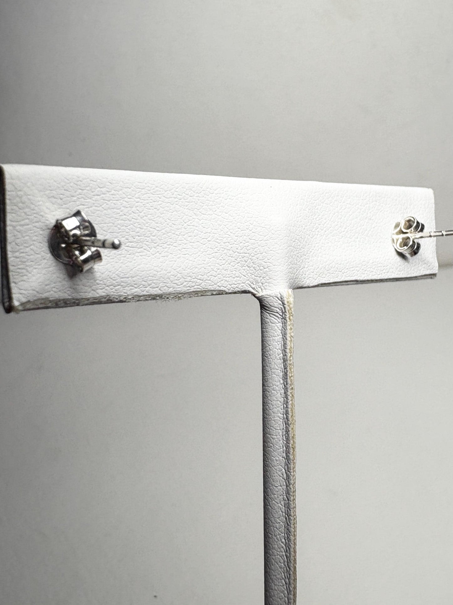 Sterling silver stud earrings with garnets and zircons.