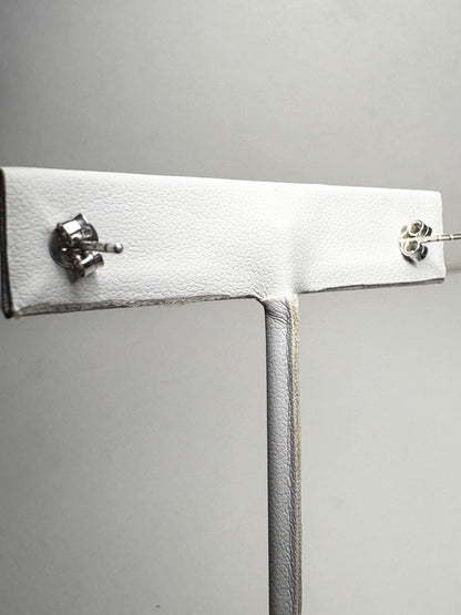 Sterling silver stud earrings with garnets and zircons.