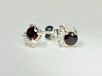 Sterling silver stud earrings with garnets and zircons.