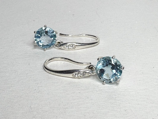 Sterling silver dangle earrings with blue topaz and white zircon.