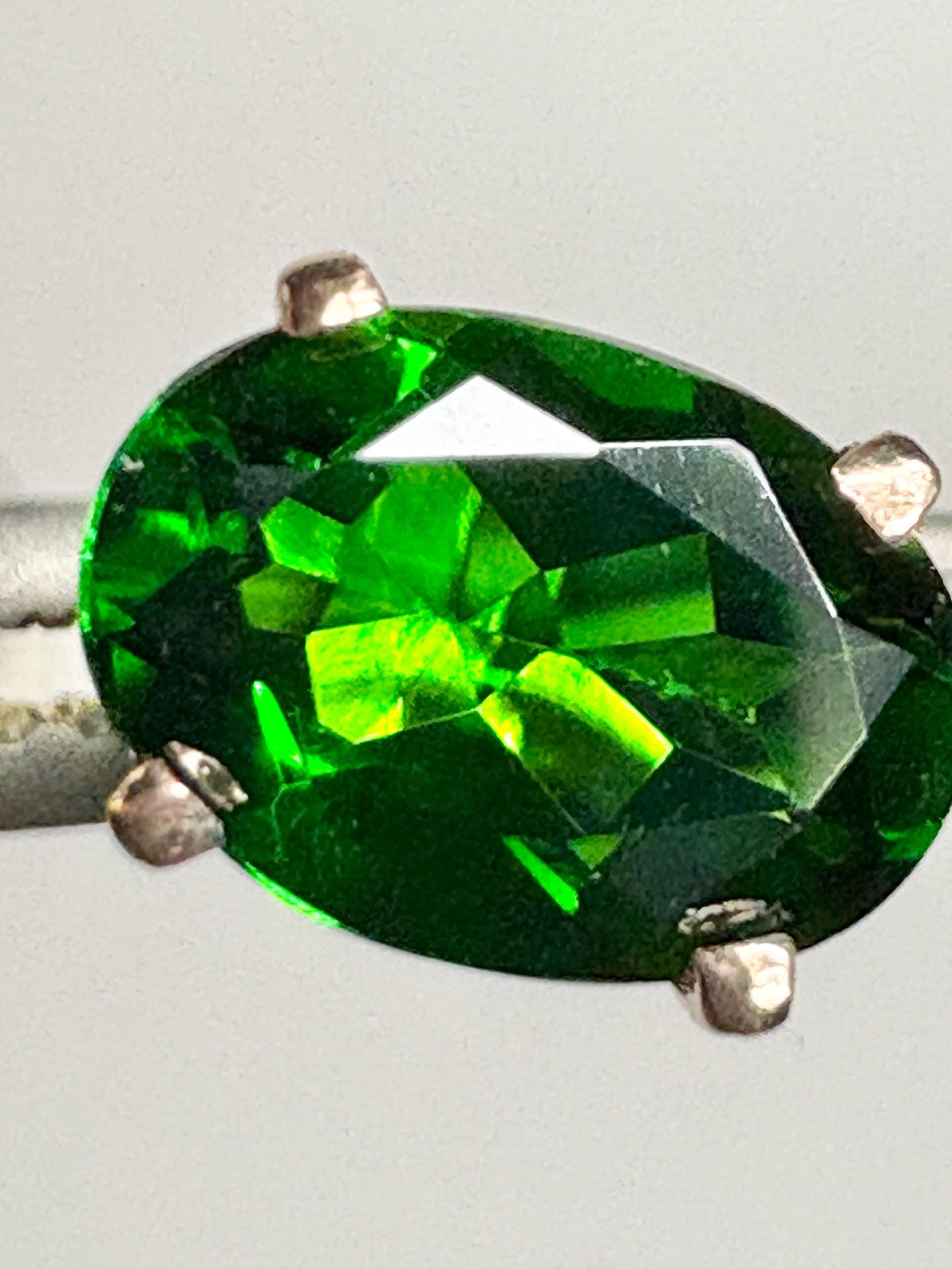 Oval chrome diopside stud earrings in 14k gold.