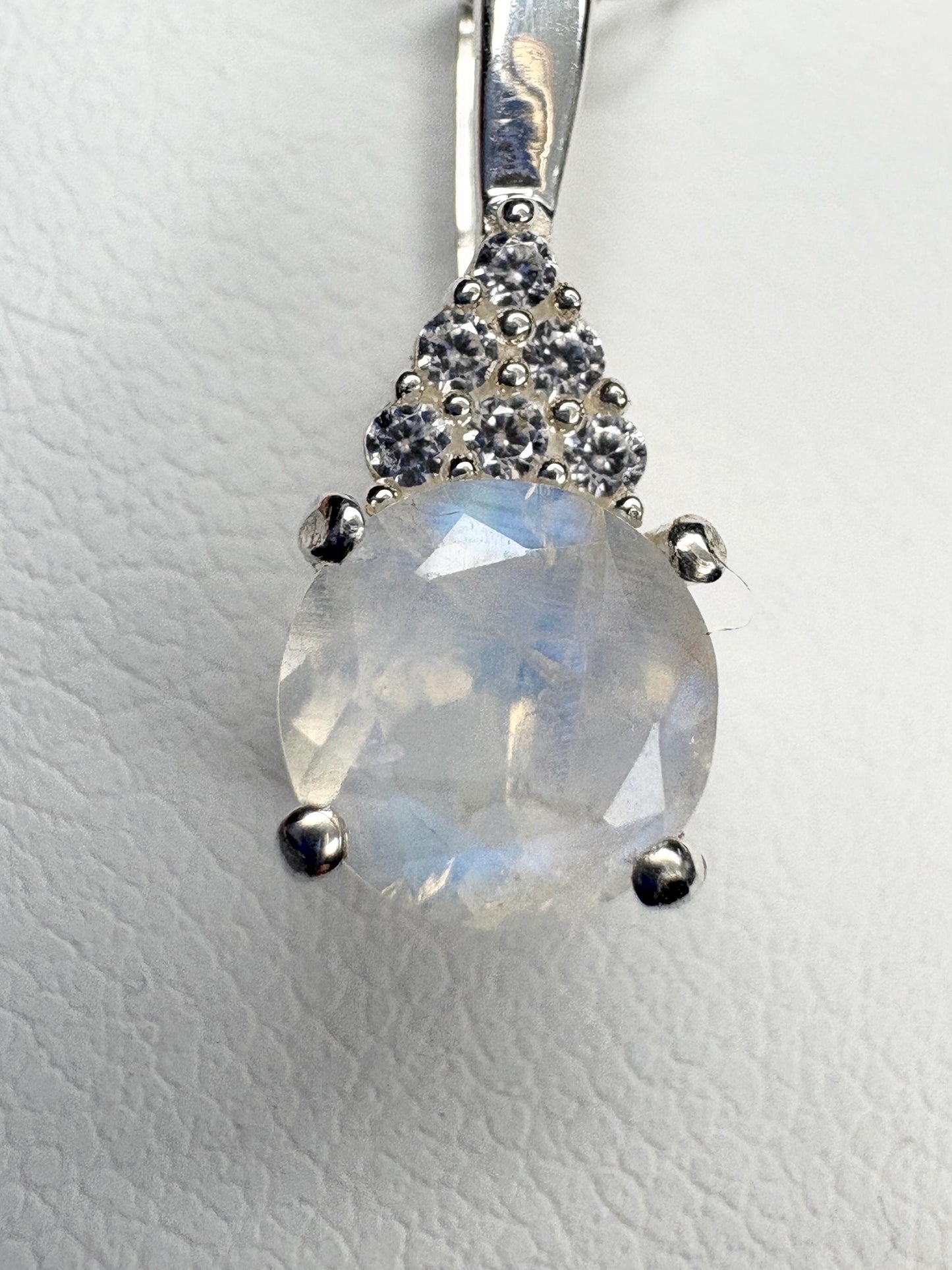 Sterling silver pendant with rainbow moonstone and zircon accents.