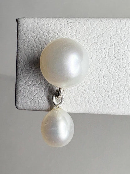 Sterling silver dangle earrings with two freshwater cultured pearls.