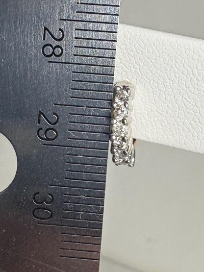 Tiny 14k gold hoop earrings with natural diamonds, measuring approximately 10mm.