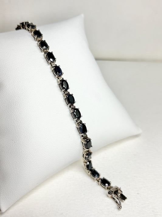 Oval dark blue sapphire tennis bracelet in stainless steel with sterling silver.