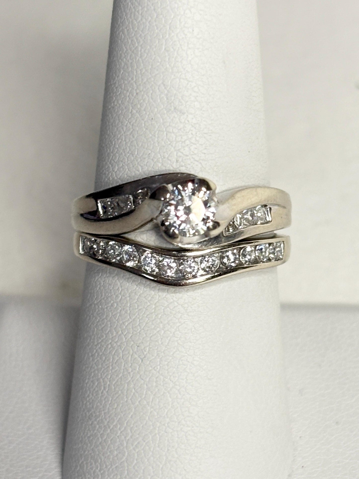 Contoured 14k white gold wedding band with channel-set diamonds.