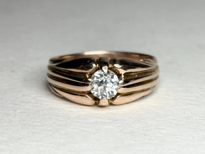 Vintage 10k rose gold ring with an old mine cut diamond on a wide band.