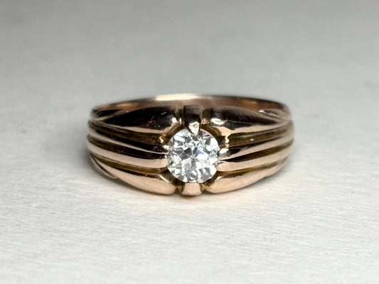 Vintage 10k rose gold ring with an old mine cut diamond on a wide band.