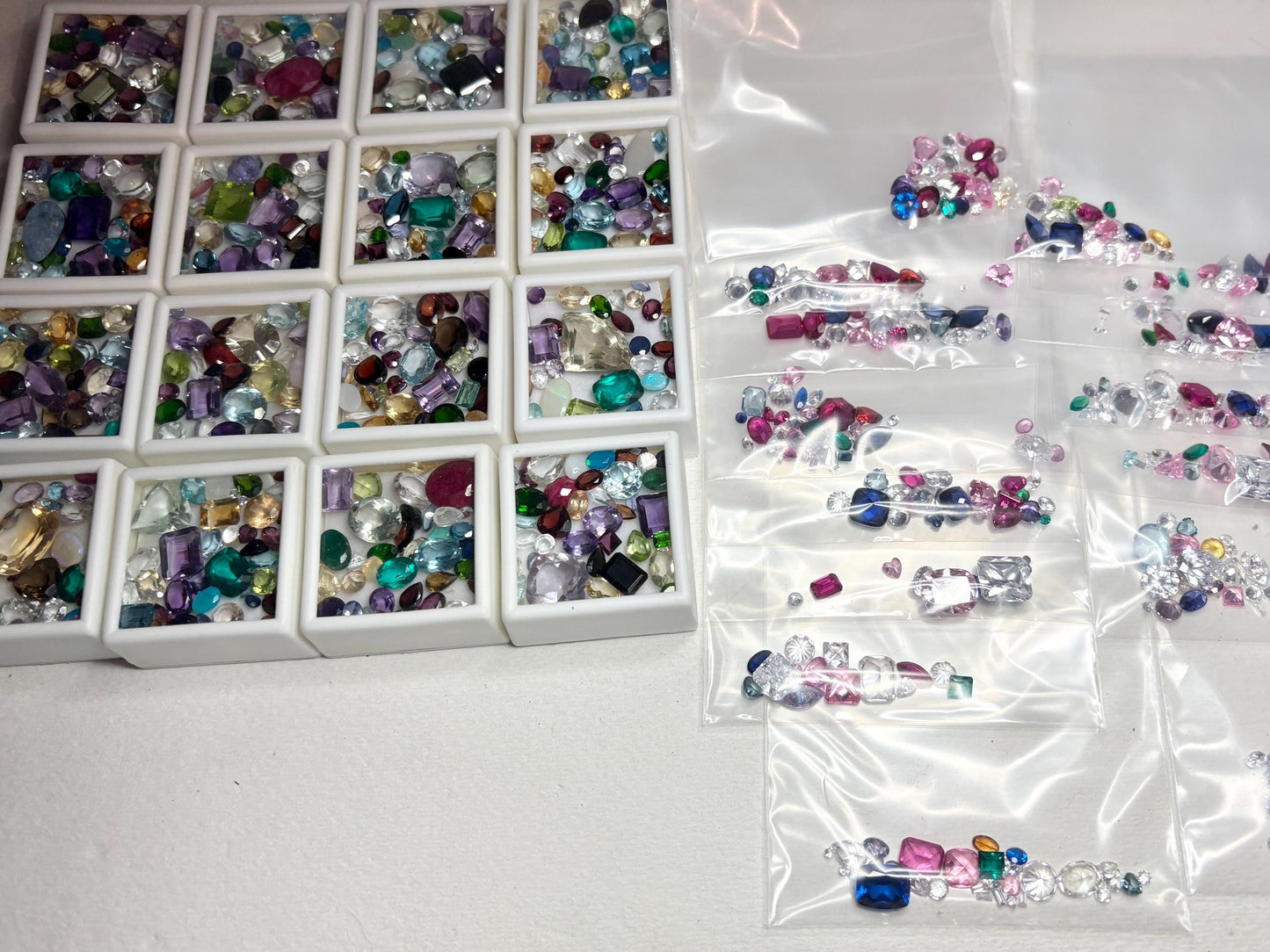 A parcel of mixed faceted natural and synthetic gemstones in various colors and shapes.
